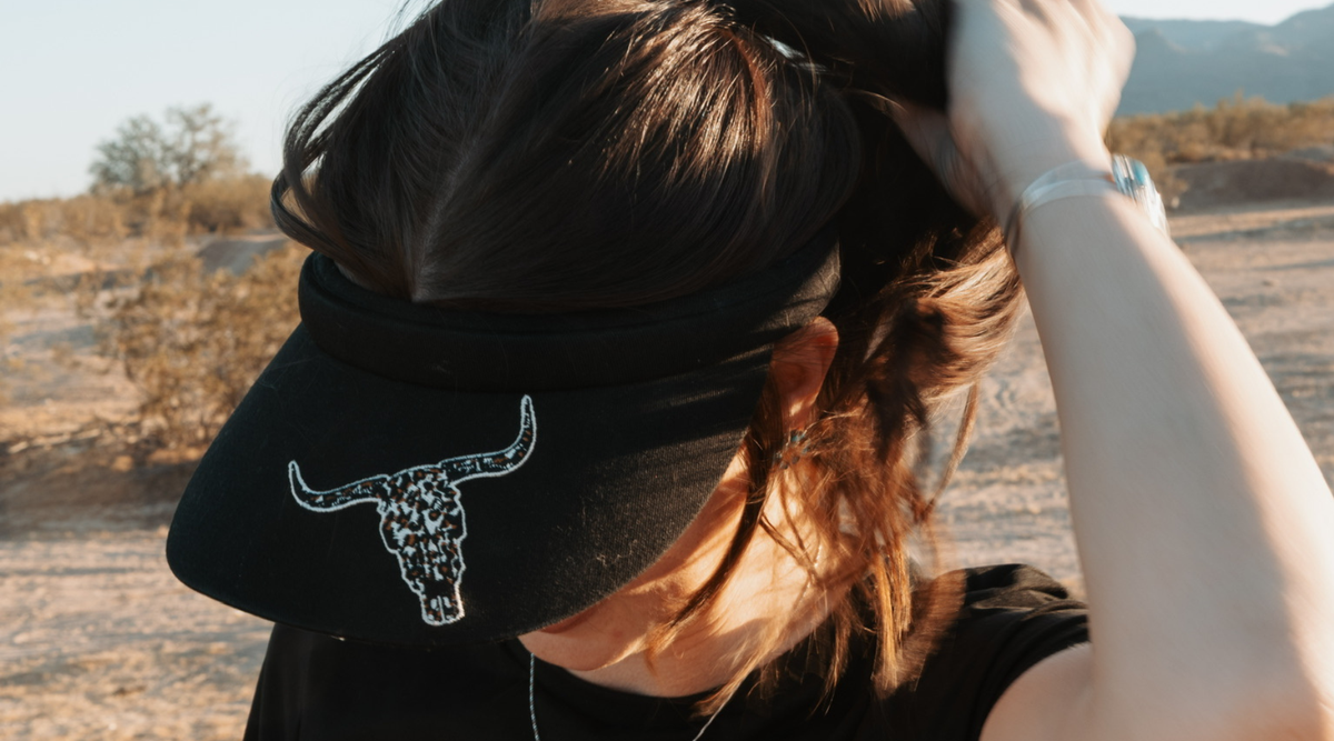 Cowgirl wearing a Cowboy Hardware women's cap.