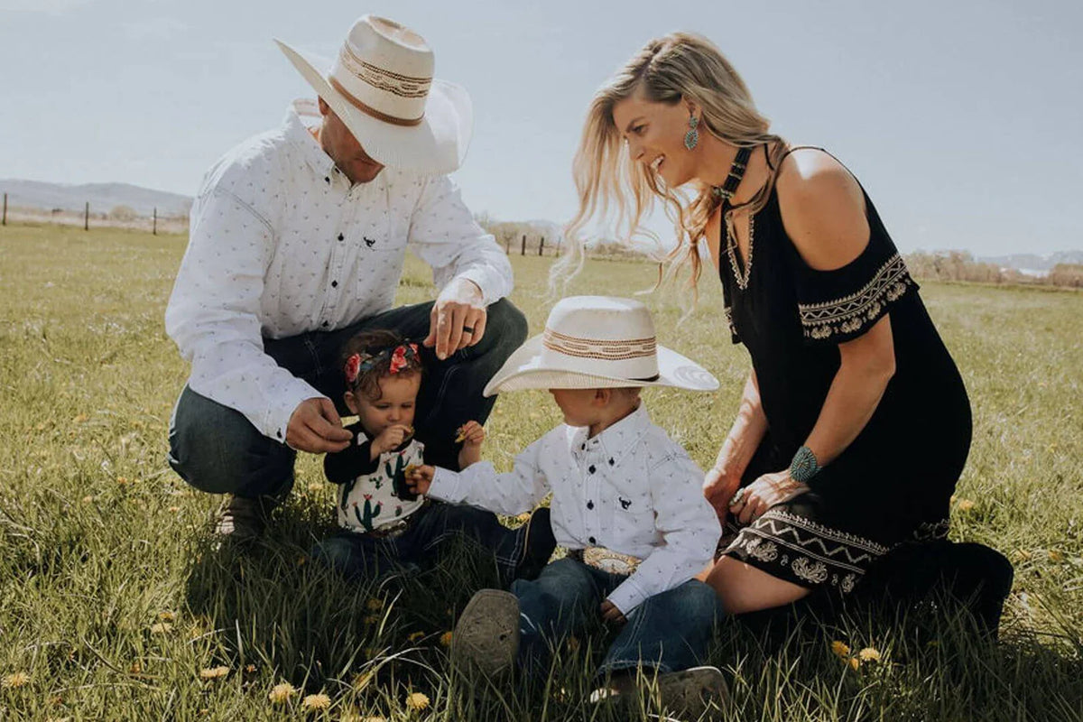 Family on ranch in matching western wear from Cowboy & Cowgirl Hardware