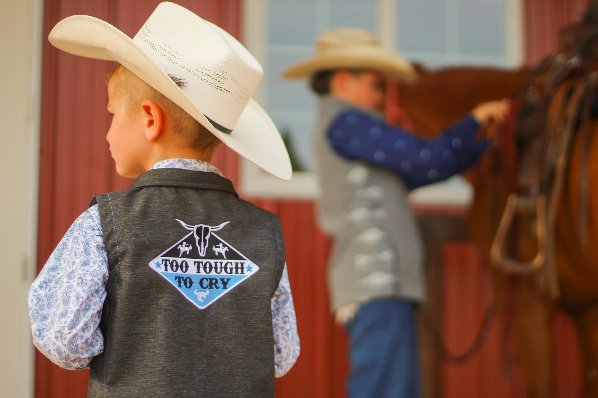 Little cowboys wearing western outerwear from Cowboy and Cowgirl Hardware