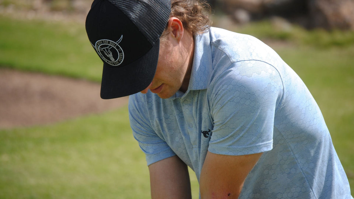 Man golfing while wearing a Cowboy Hardware Men's Western Polo