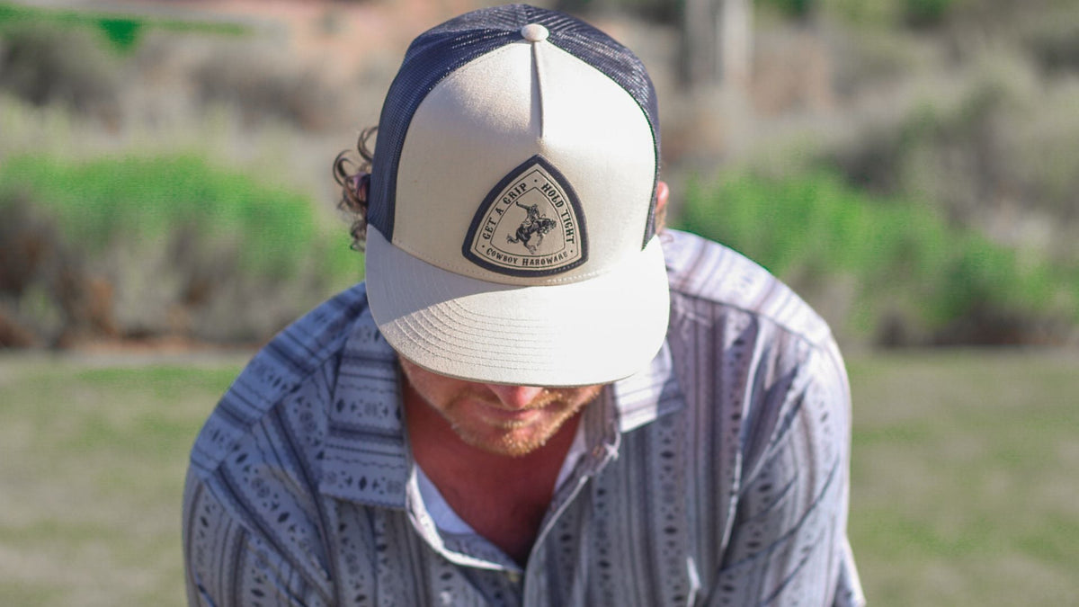 Cowboy golfing wearing a men's cap from Cowboy Hardware