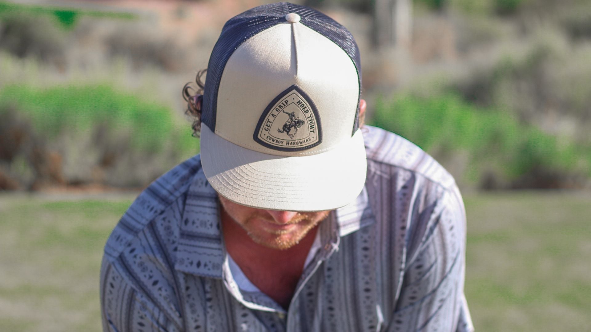 Cowboy golfing wearing a men's cap from Cowboy Hardware