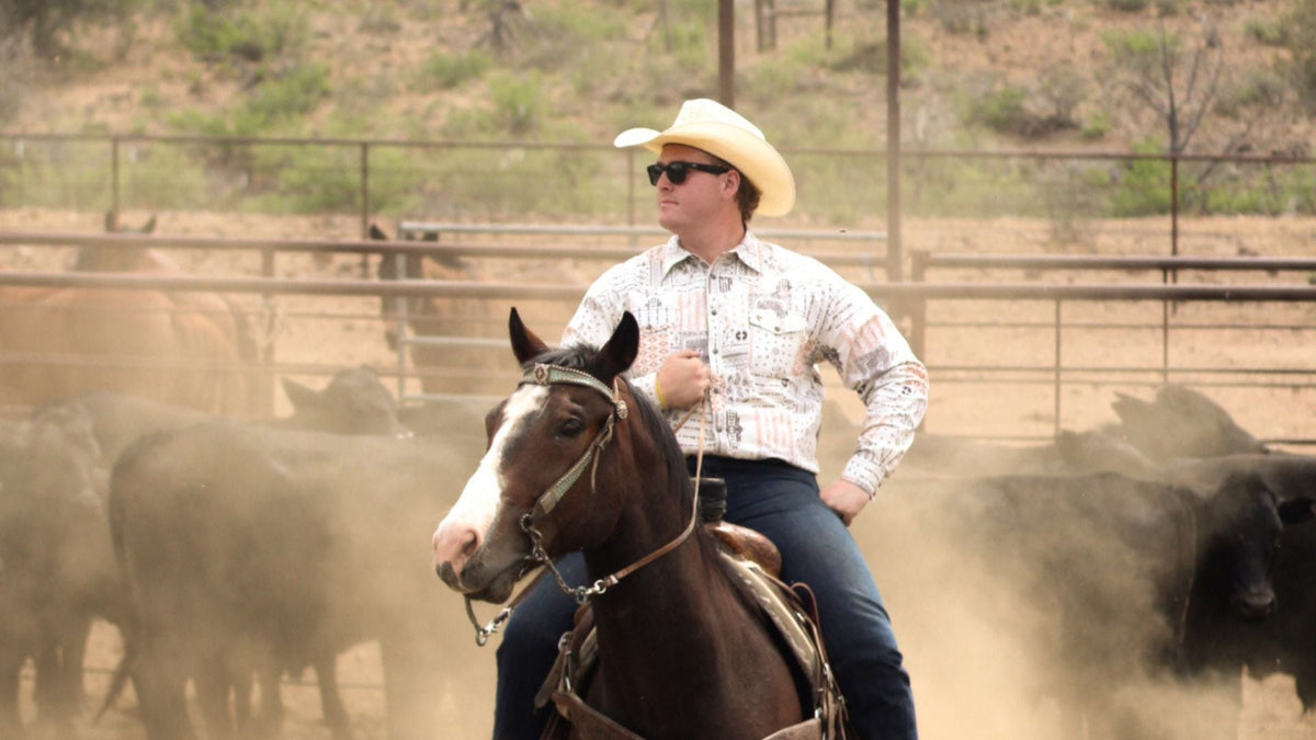Cowboy riding horse wearing men's western wear from Cowboy Hardware