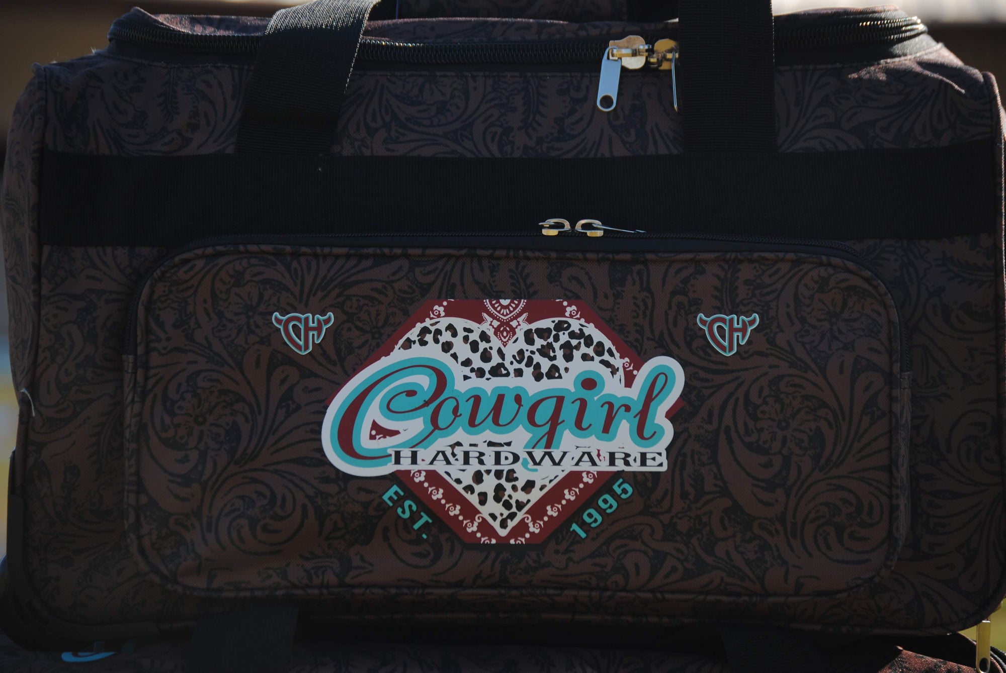 Close Up Of Our CH Fancy Heart Tooled Leather 3 Wheel Bag from Cowgirl Hardware 