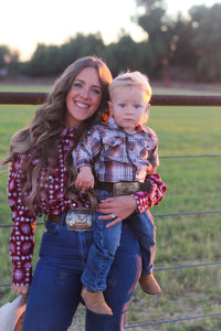 Mother with her young cowboy on the ranch.