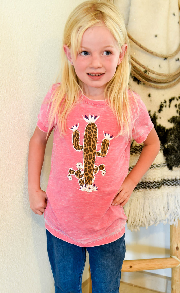 Little cowgirl wearing leopard print cactus short sleeve shirt