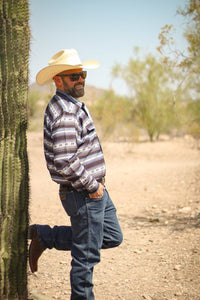 Cowboy hanging out near a cactus, wearing Men's Cowboy Hardware Navy Striped Aztec Long Sleeve Print Western Shirt.