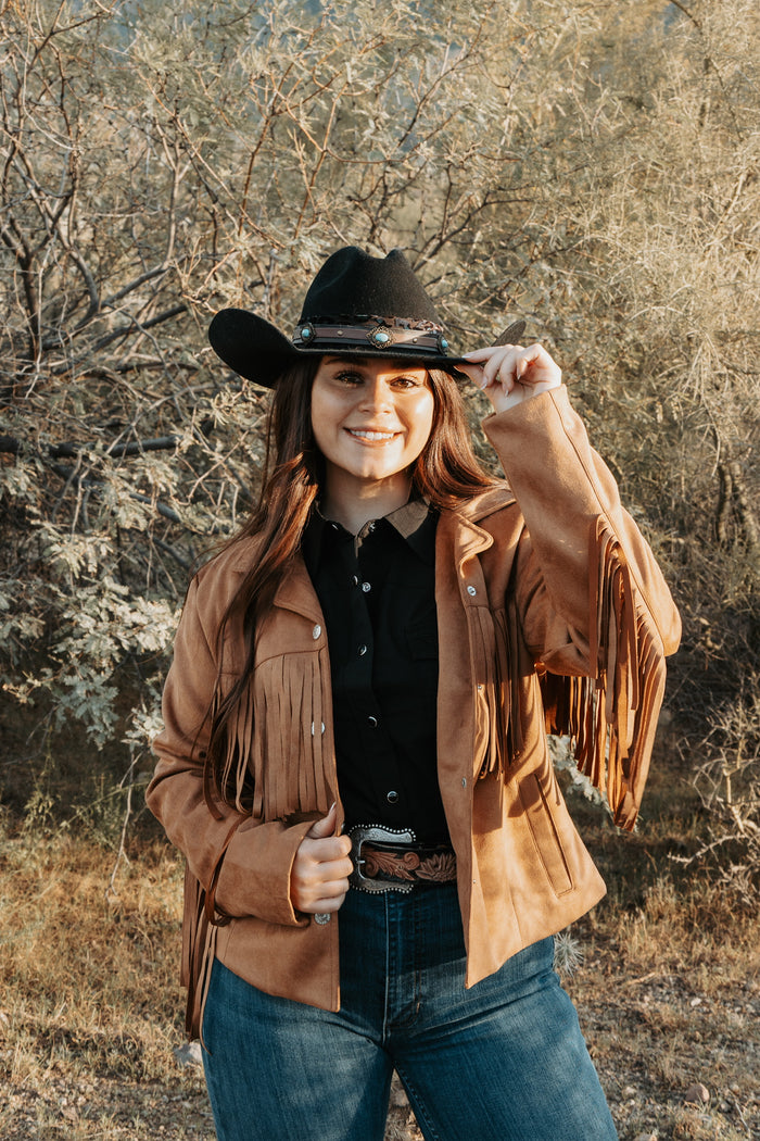 Cowgirl enjoying the ranch wearing her Faux Suede V Fringe Jacket.