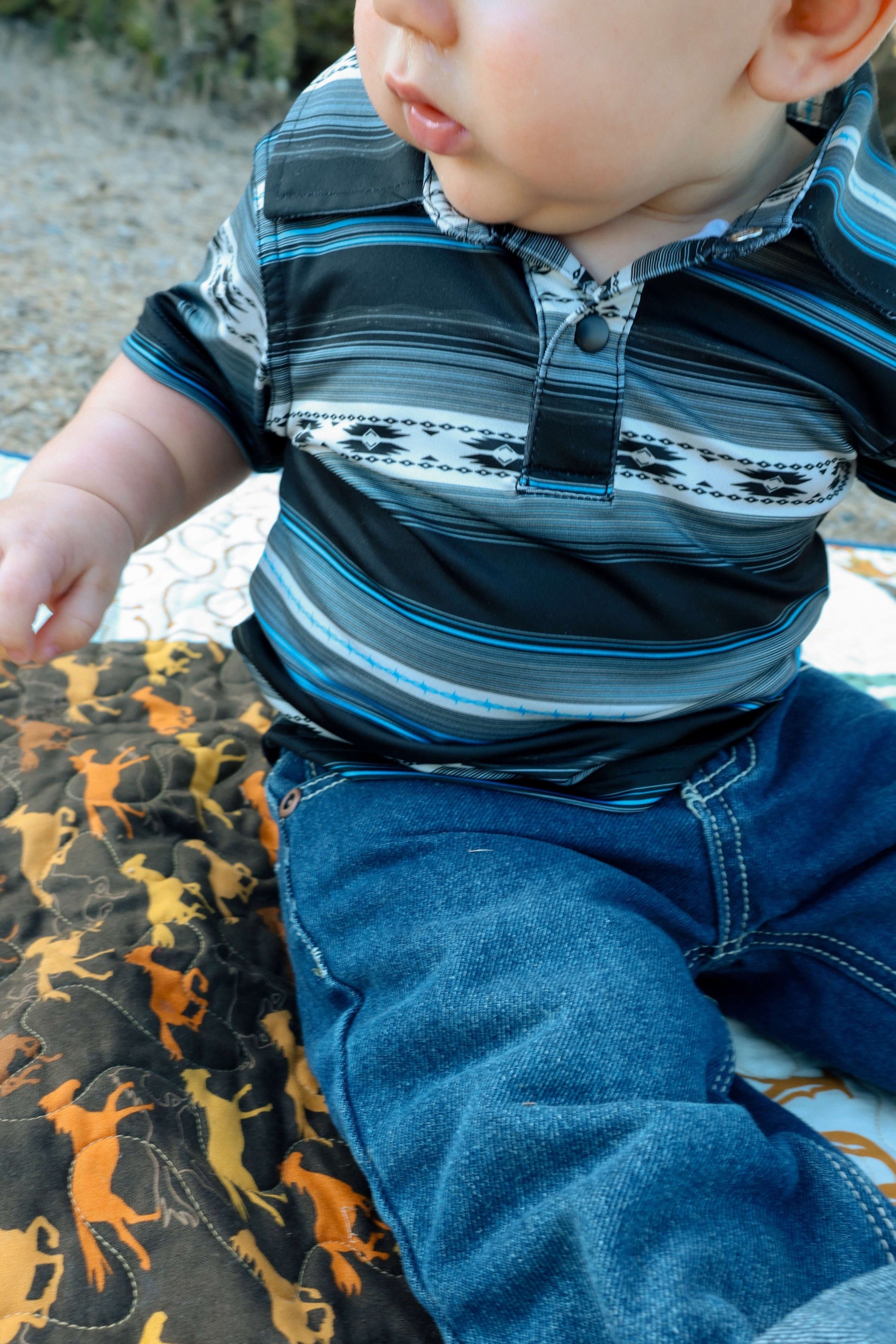 Little cowboy wearing Cowboy Hardware's infant and toddler boy's CH black "striped aztec" short sleeve polo shirt