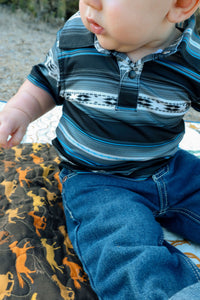 Little cowboy wearing Cowboy Hardware's infant and toddler boy's CH black "striped aztec" short sleeve polo shirt