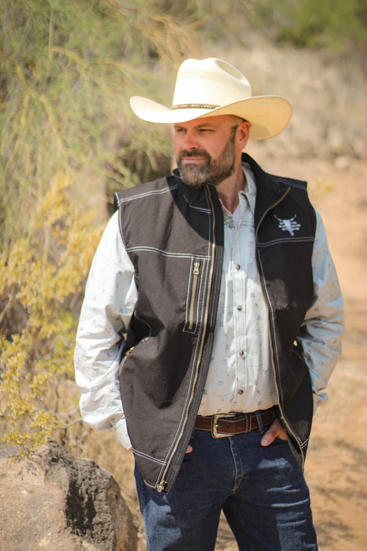Man checking on his cattle wearing a Men's CH Grey "Branding Irons" Long Sleeve Western Shirt