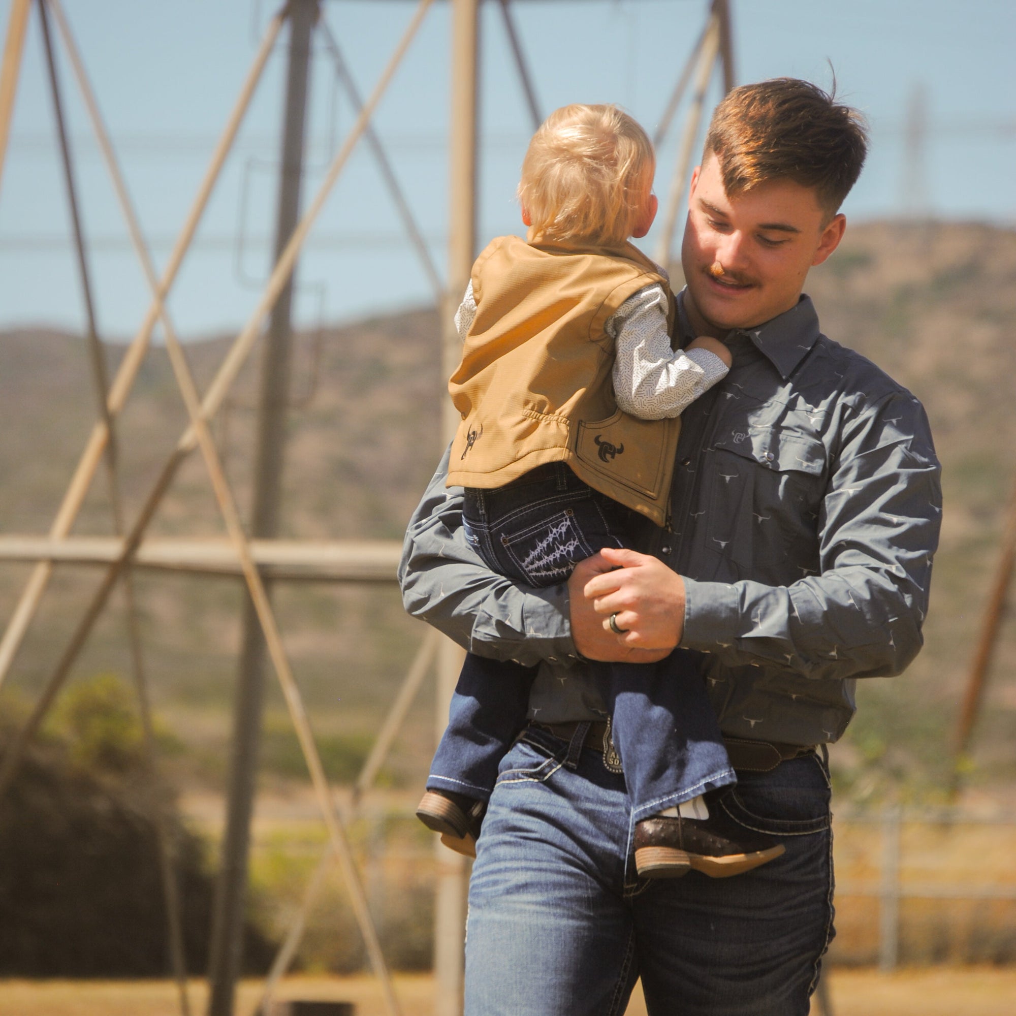 A man walking with his son wearing Gray-"Skull-Burst" Long Sleeve Western Shirt