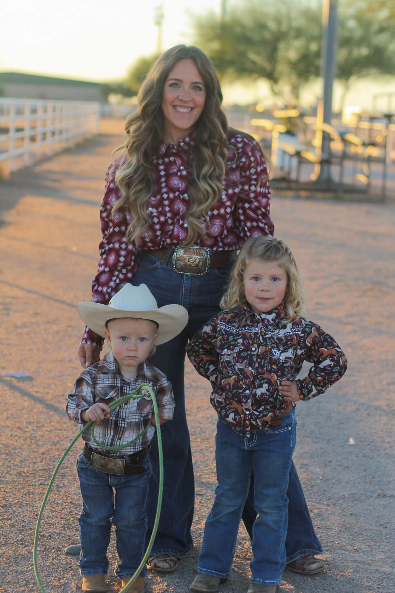 Mother with her two young children on the ranch.