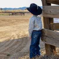 Young cowboy admiring the farm.