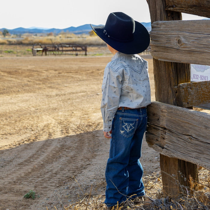 Young cowboy admiring the farm.