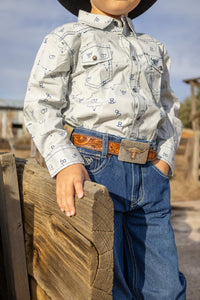 Young cowboy looking out at the ranch.