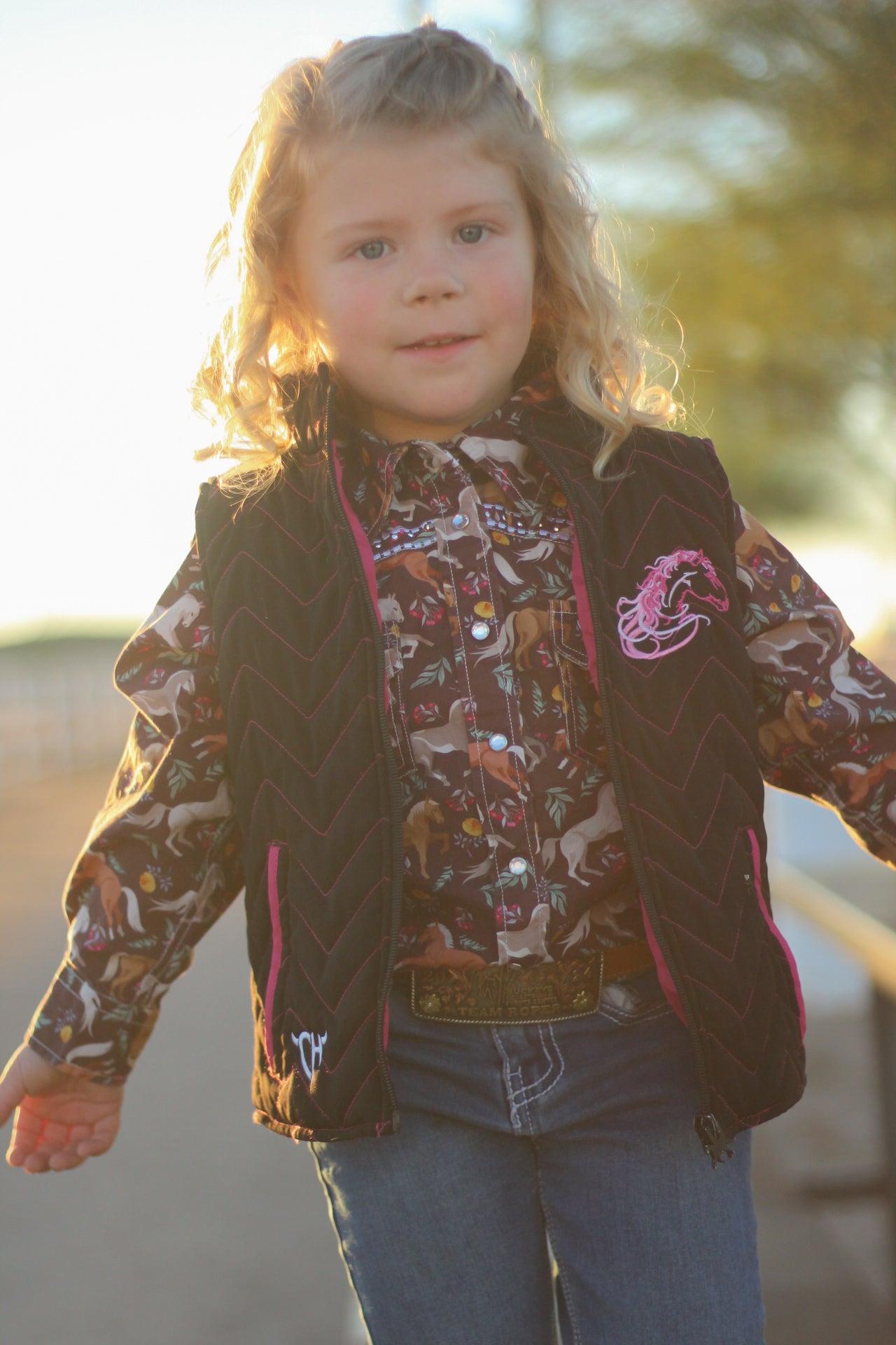 Young cowgirl playing in the sun on their ranch.