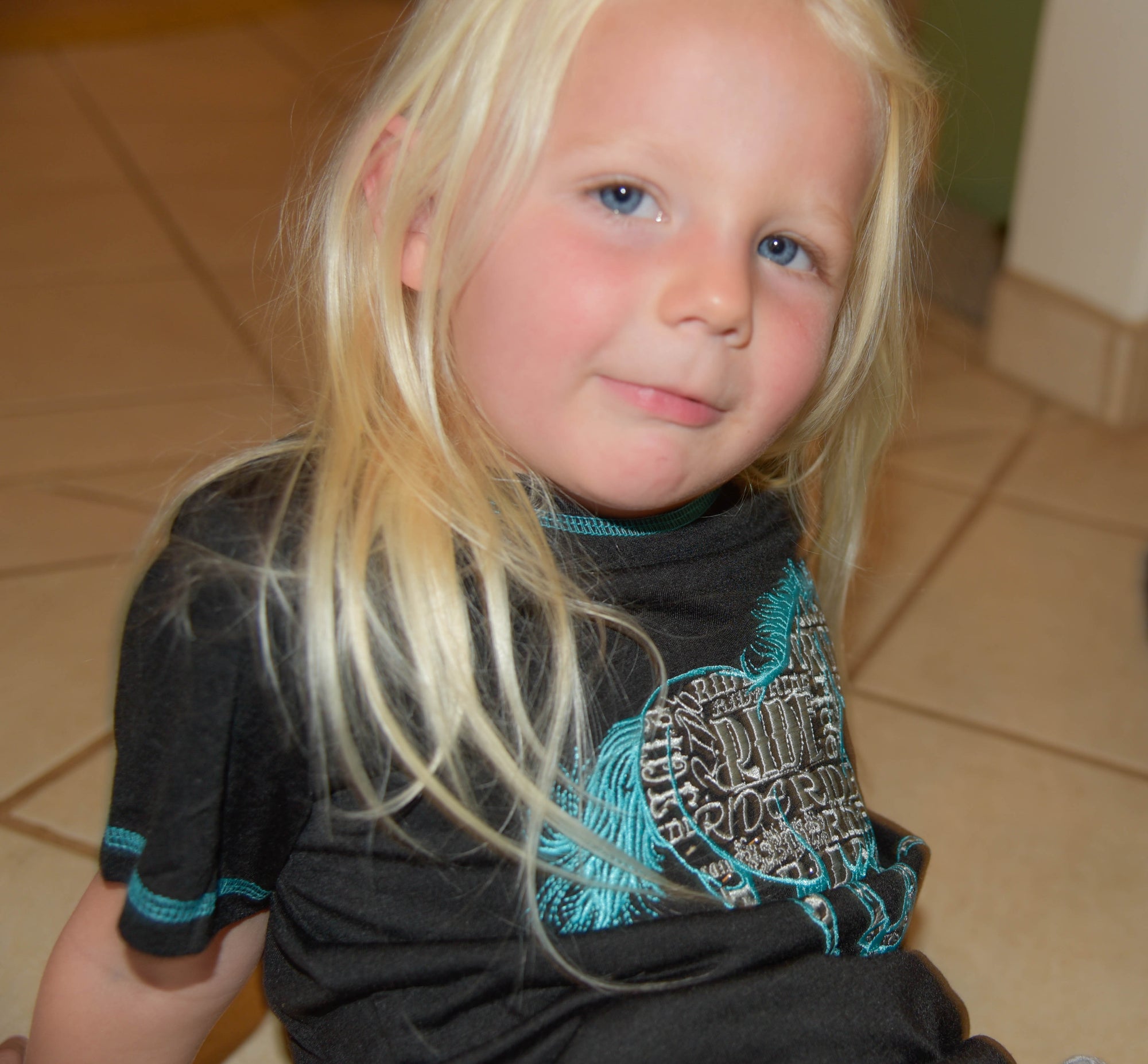 Young Cowgirl wearing CH "Ride Horse" Black Short Sleeve Shirt