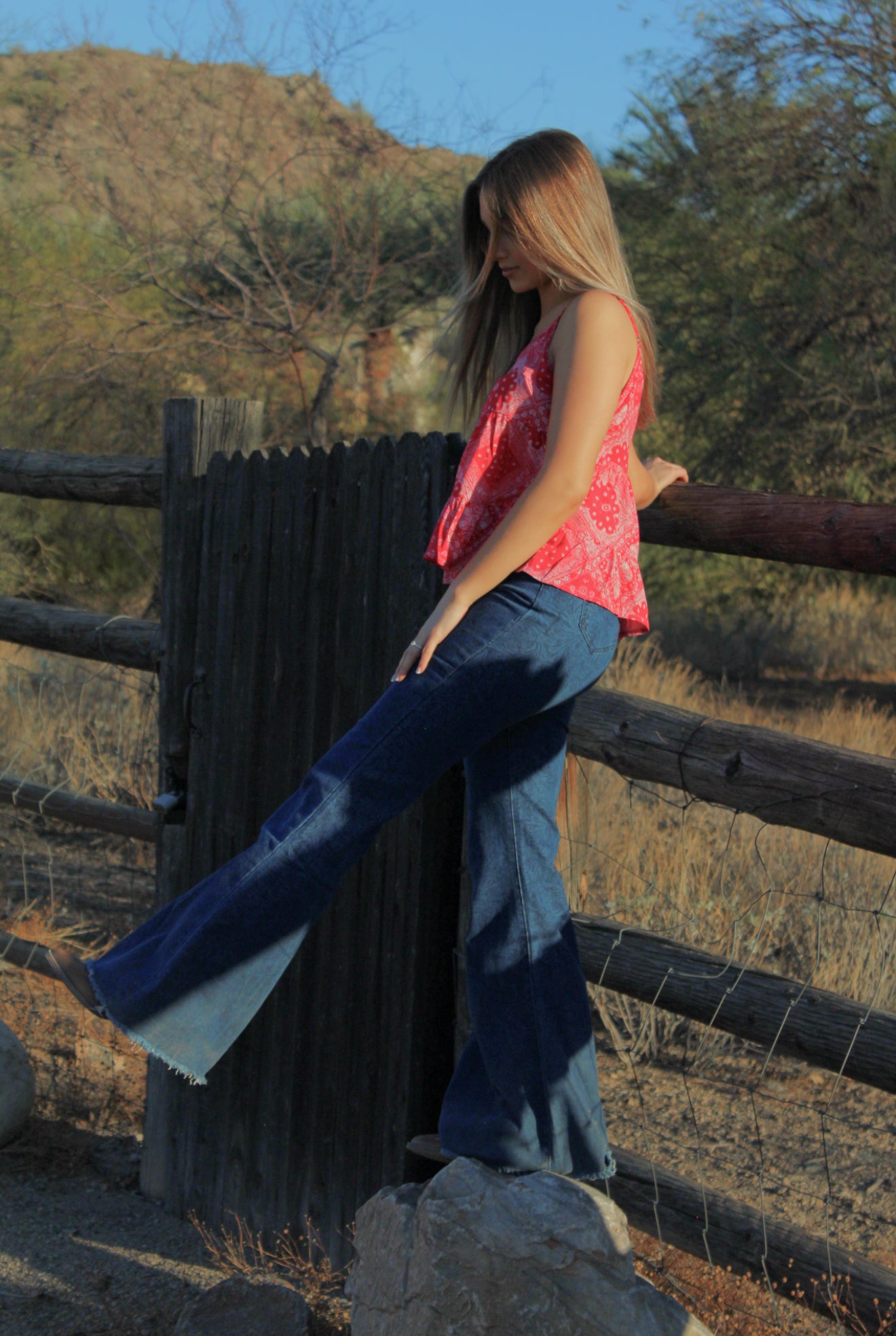 Young cowgirl wearing Women’s CH Medium Washed Tooled with Navy Flare Leg Jeans.