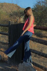 Young cowgirl wearing Women’s CH Medium Washed Tooled with Navy Flare Leg Jeans.